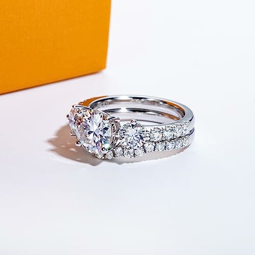 Elegant diamond engagement ring set with multiple stones on a reflective surface