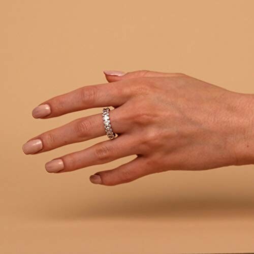 Hand wearing a diamond eternity ring