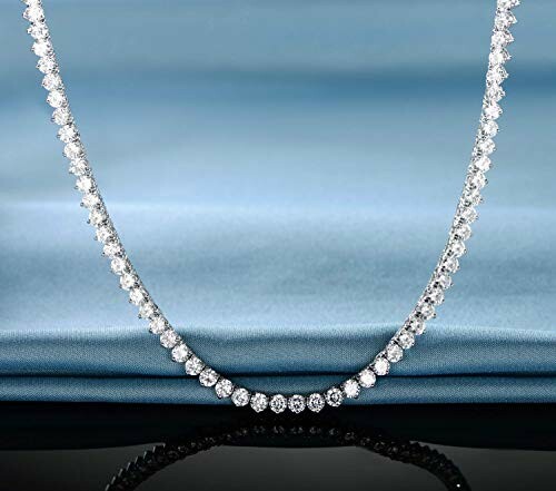 Elegant diamond necklace on blue fabric background