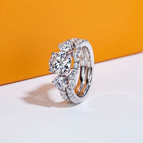 Elegant diamond ring set against an orange background