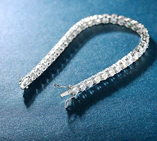 Elegant diamond tennis bracelet on blue surface