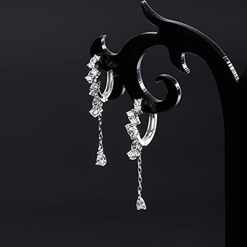 Elegant dangle earrings with cubic zirconia on display stand.