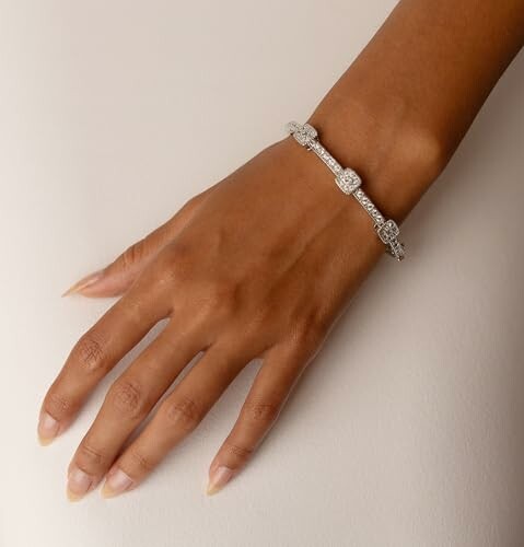 Hand wearing an elegant diamond bracelet