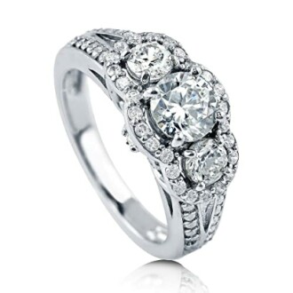 Elegant diamond engagement ring with three stones and intricate band design.