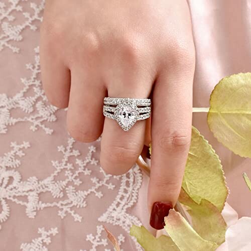 Hand wearing an elegant diamond wedding ring set.