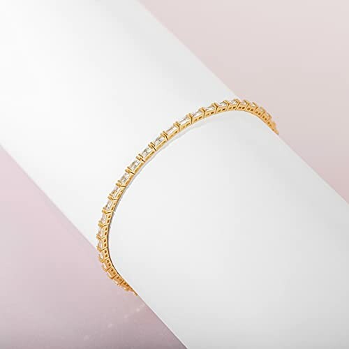 Elegant gold bracelet displayed on a white background