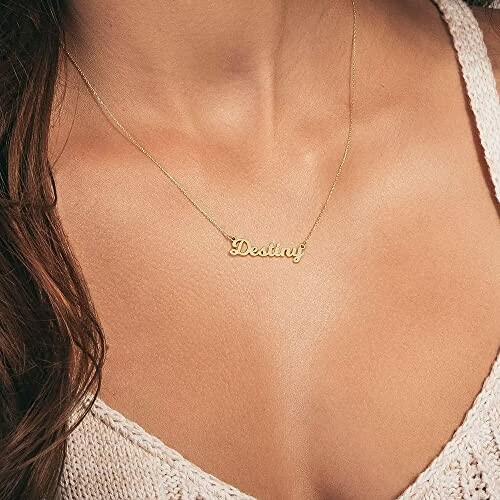 Close-up of a gold necklace with the name Destiny on a woman's neck