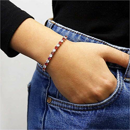 Person wearing a red and white bracelet with hand in pocket.