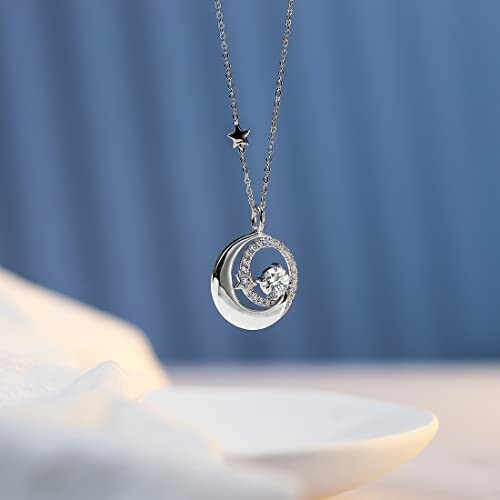 Silver necklace with crescent moon and star pendant.