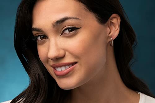 Smiling woman with dark hair and hoop earring