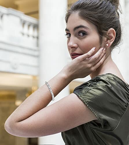 Woman wearing an elegant bracelet, in a formal setting