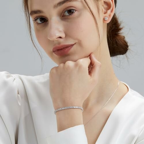 Woman wearing earrings, necklace, and bracelet