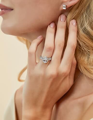 Woman wearing a pear-shaped ring and earrings