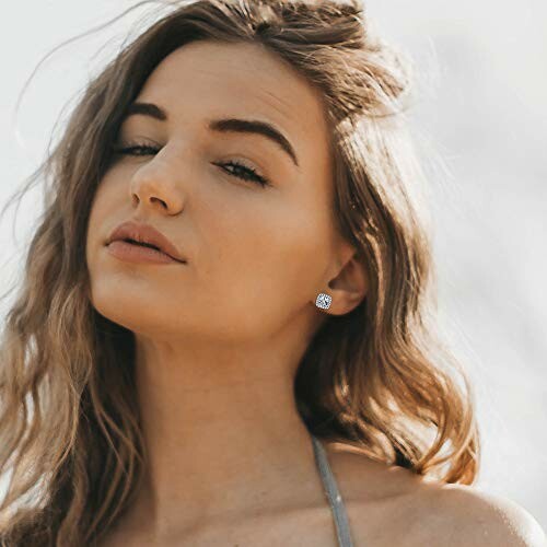 Woman with long hair wearing earrings.